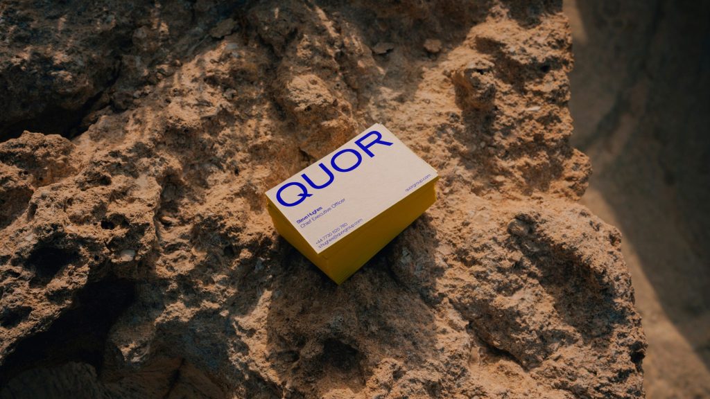 Quor visual identity business cards on rock