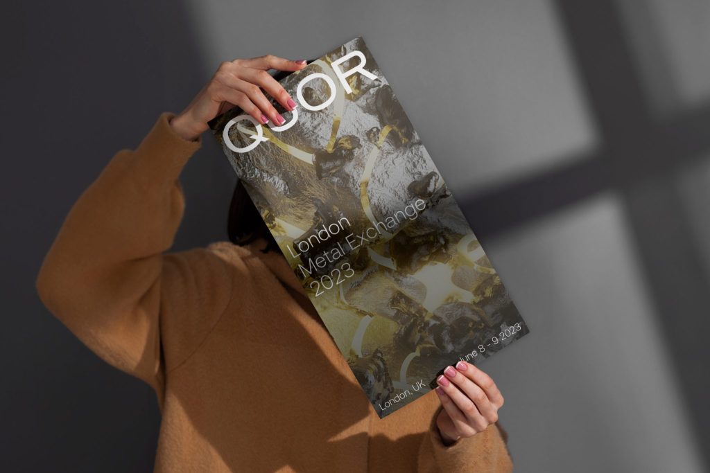 Quor visual identity poster held by woman